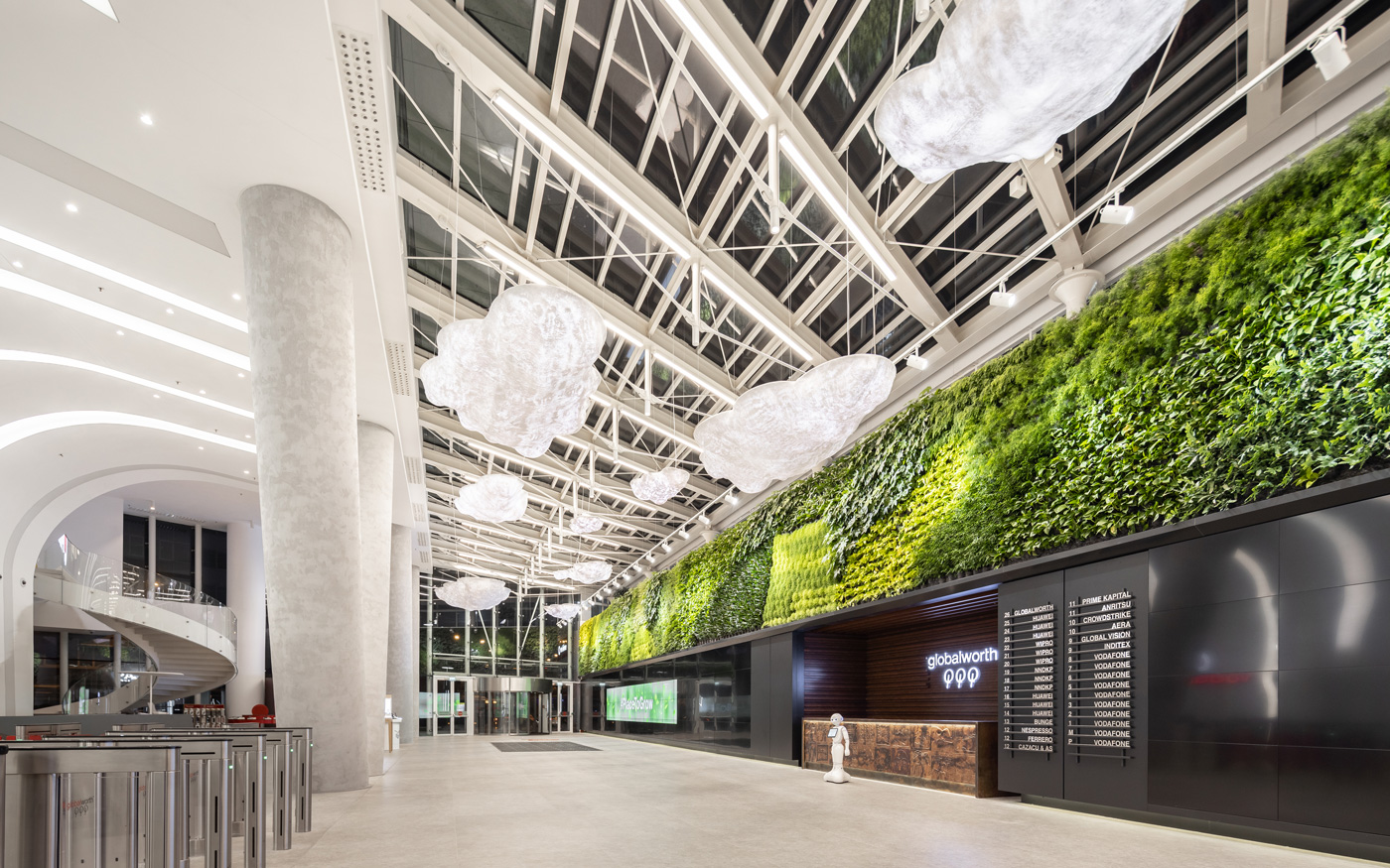 An image of a large indoor space with wall planting and lighting
